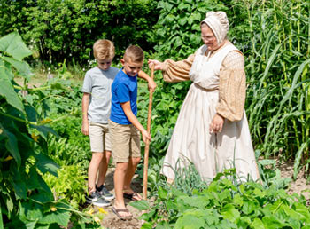 Kids-hoeing-in-garden-with-interpreter