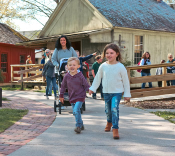 mom-and-kids-going-around-Village-Green