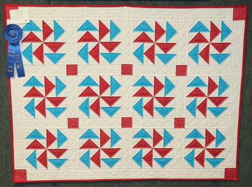 Dutchmans-Puzzle-SmallHandQuilted-Quilt-winner-QuiltShow2025