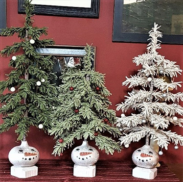 three wool pine trees with snowman bases