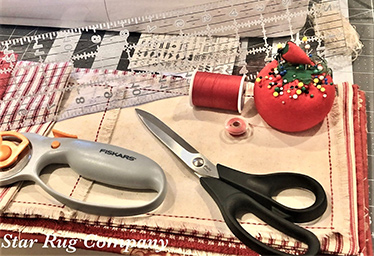 scissors, pins, thread, rotary cutter, ruler