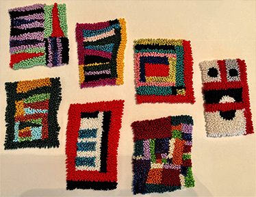 display of multicolored designed rugs