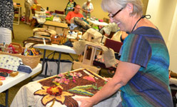 Rug hooking artist working on rug
