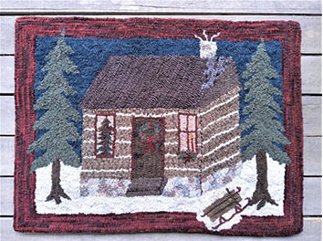 Winter cabin with sled rug hooked by Jenny Smallridge