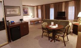 Well-appointed room with seating area and king-size bed at Heritage Inn